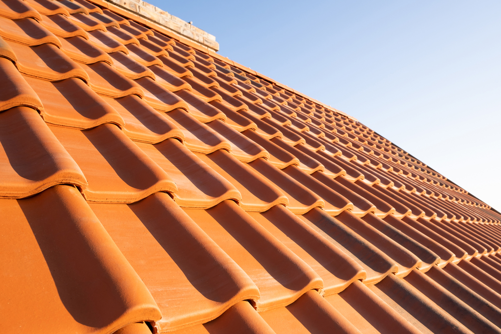 Overlapping,Rows,Of,Yellow,Ceramic,Roofing,Tiles,Covering,Residential,Building